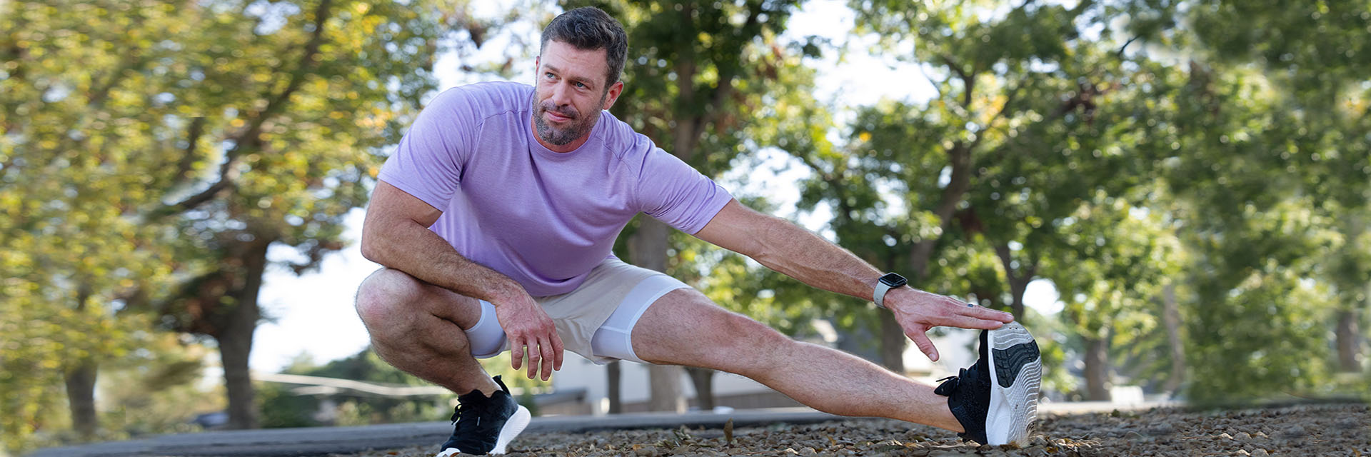Man in running shoes outdoors stretching