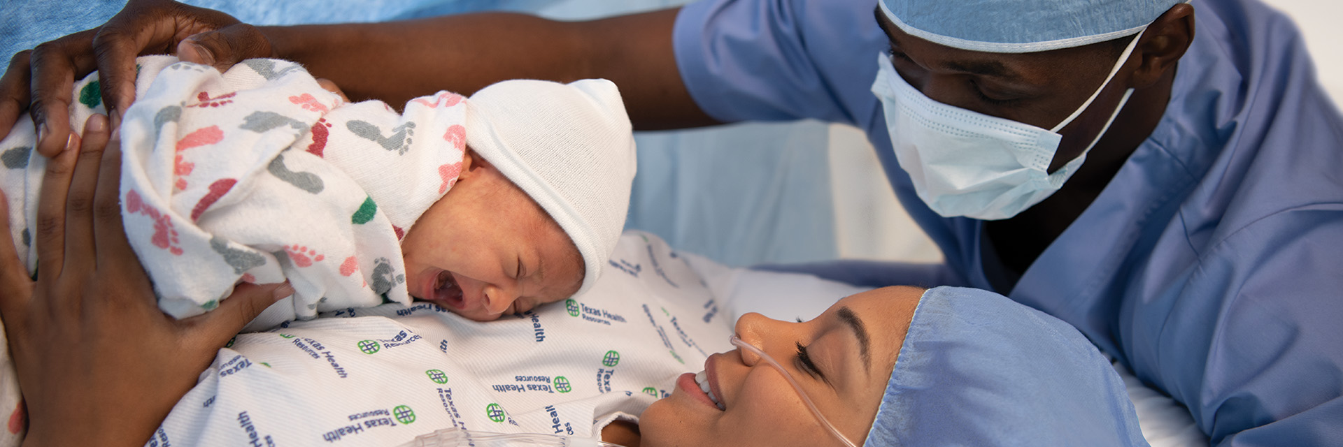 Couple with baby in hospital bed