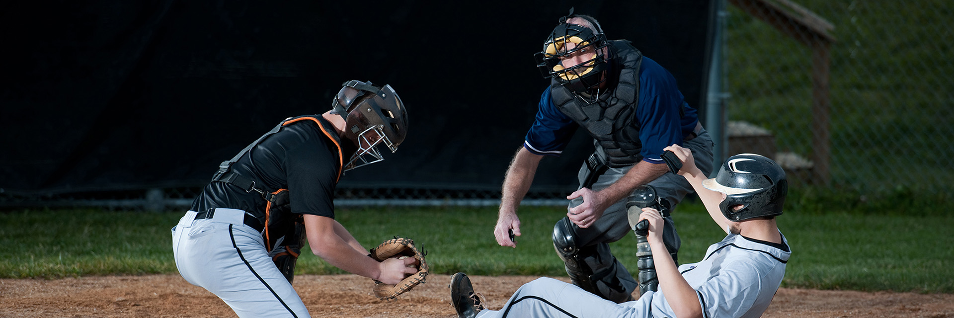Baseball player sliding home