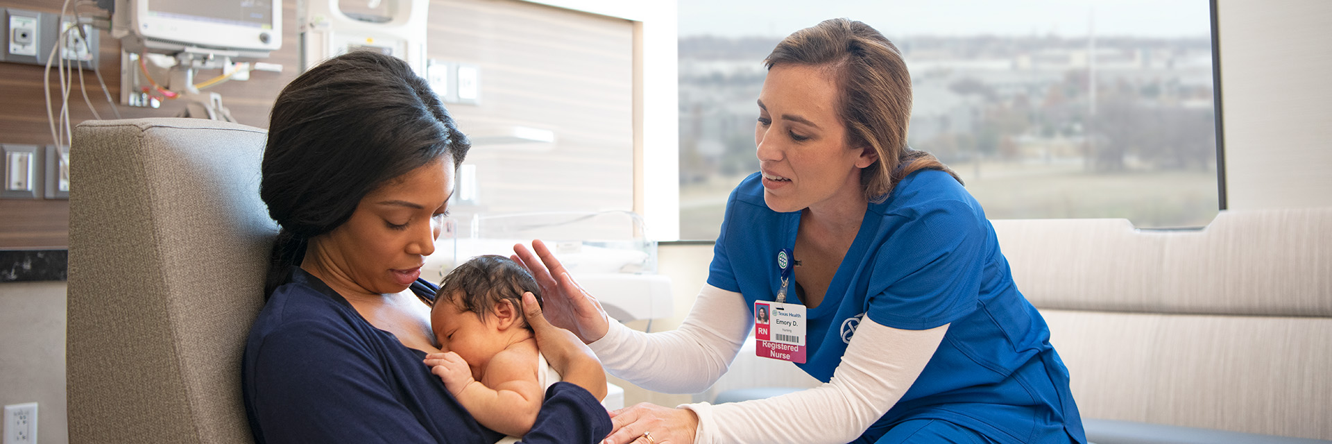 Mom breastfeeding with nurse