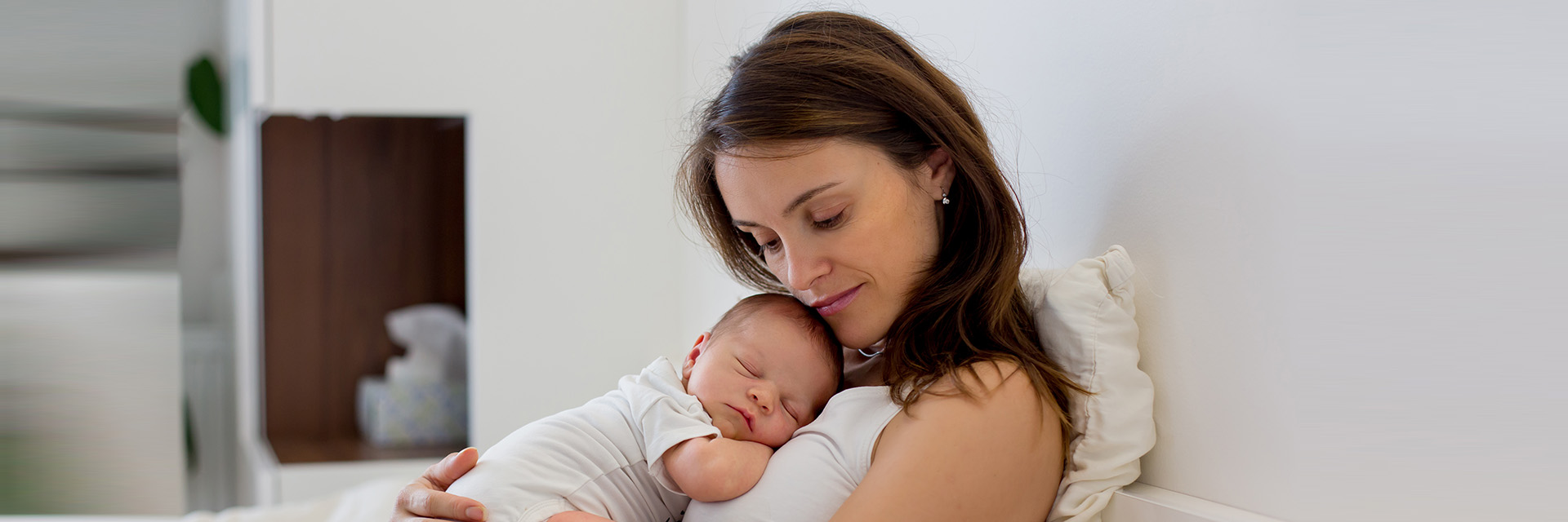Sad mom holding baby