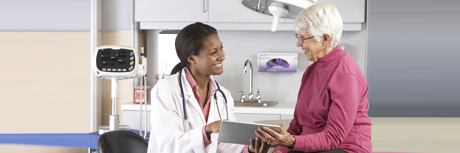 Patient with doctor using tablet