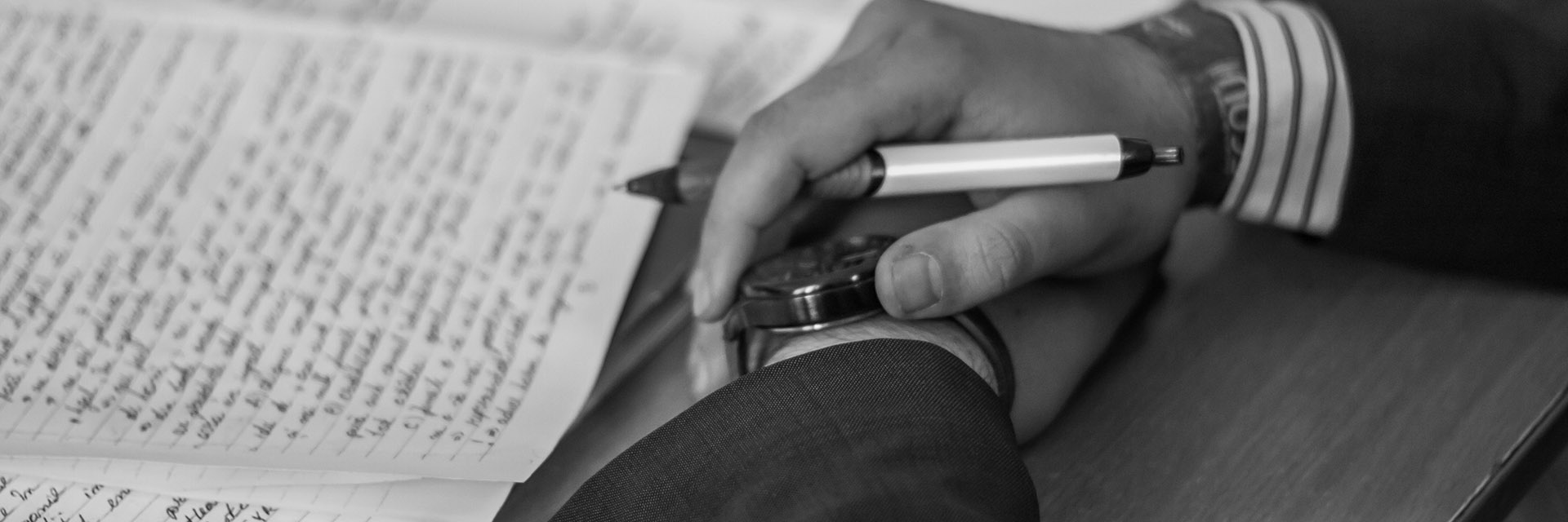 Hands Over Handwritten Document