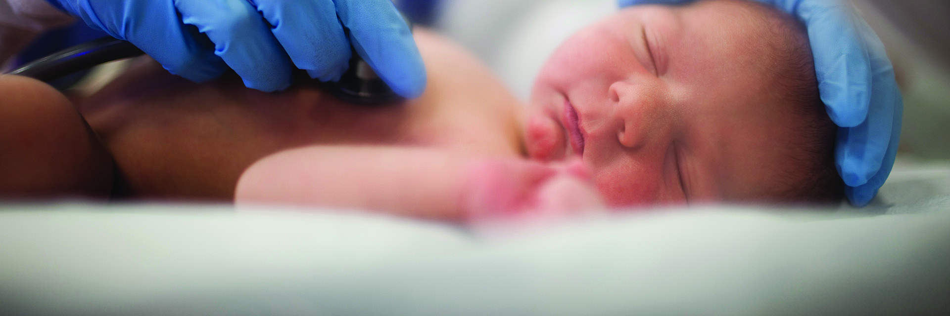 Newborn being touched by provider