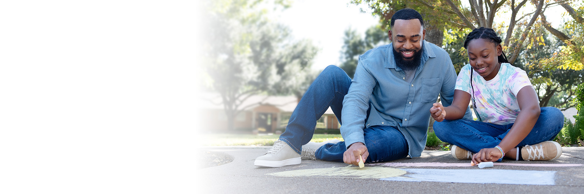 Dad and daughter playing chalk