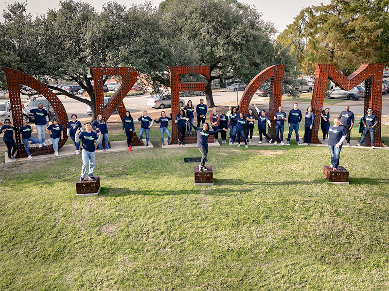Employees on the DREAM sign