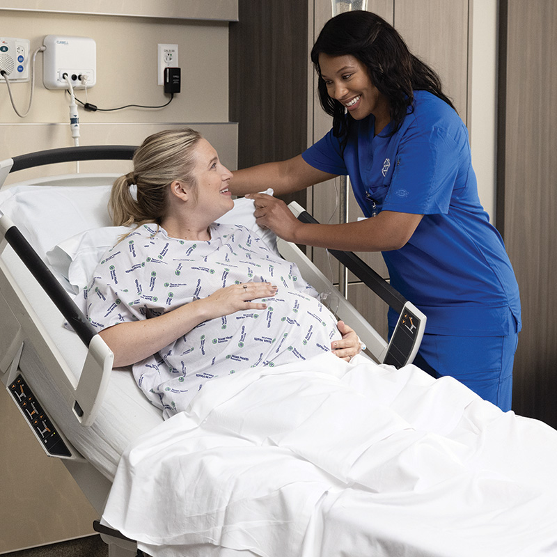 Nurse helping pregnant patient