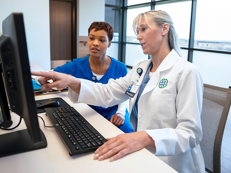 Care team reviewing patient information at a computer workstation