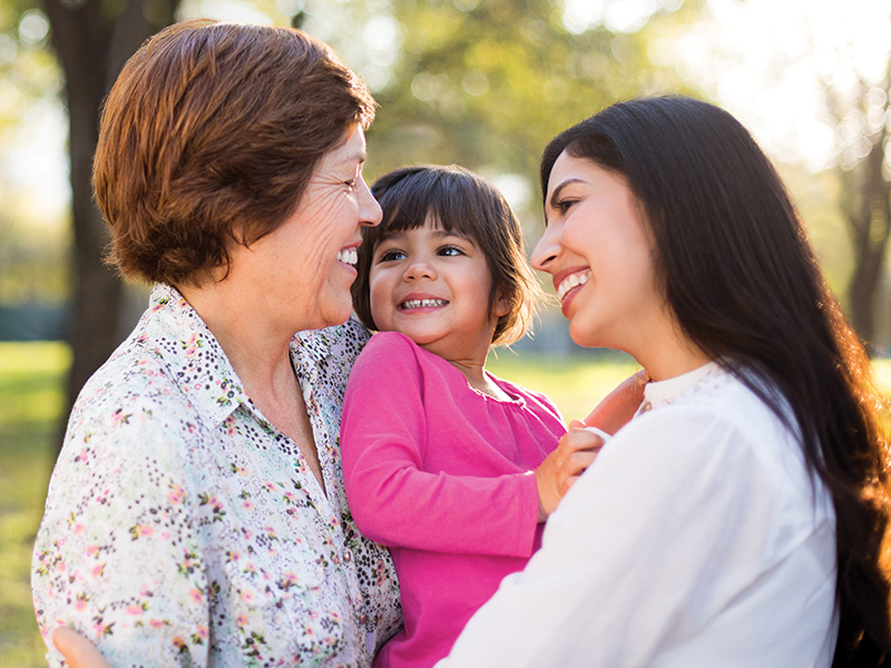 Mom, child, and grandmother hugging