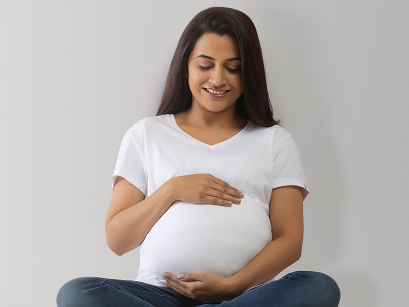 Pregnant woman holding stomach