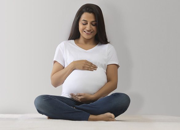 Pregnant woman holding belly