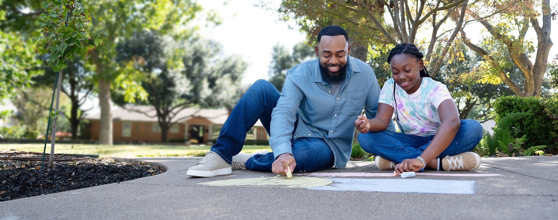 Dad and daughter playing chalk