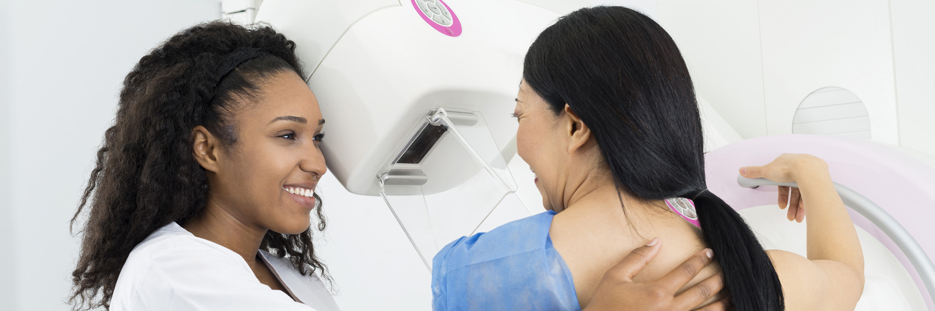 Female doctor giving patient mammogram